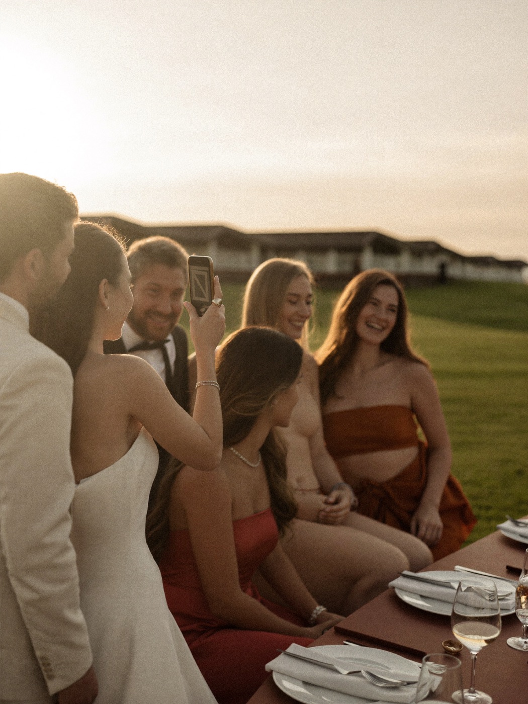 Wedding guests laughing together while taking a photo